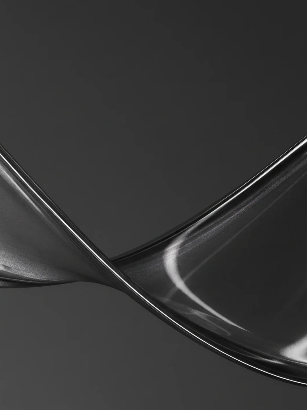 A twisted chrome form catching a single light