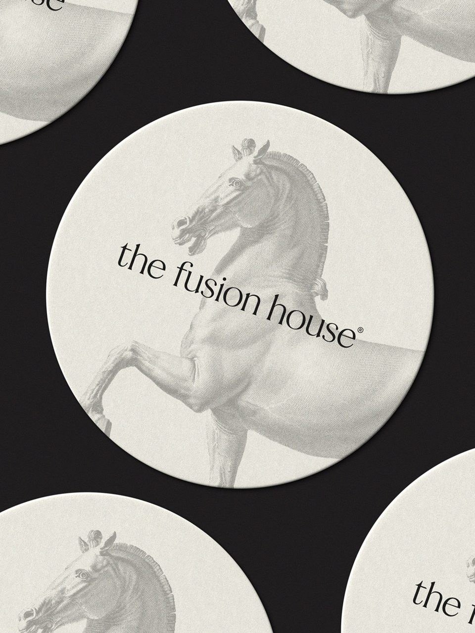 Coasters printed with the horse mark and The Fusion House wordmark