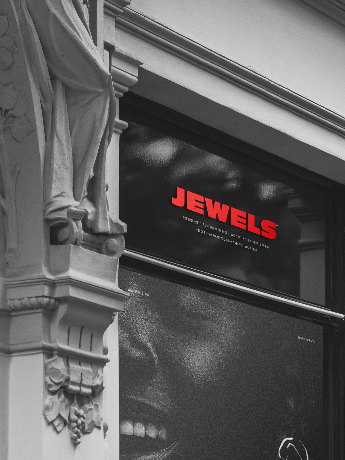 A store window under a stone arcade carrying the Jewels campaign