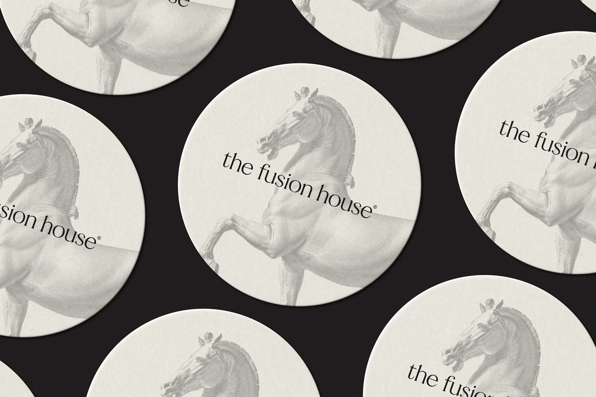 Coasters printed with the horse mark and The Fusion House wordmark
