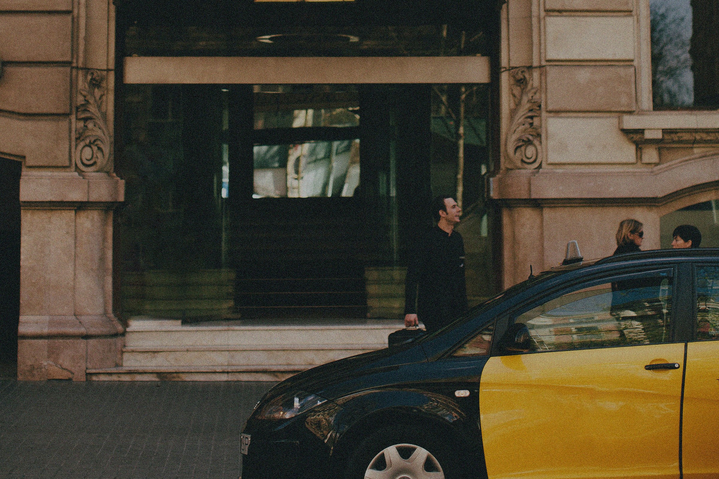 The hotel entrance in New York with a yellow cab at the door