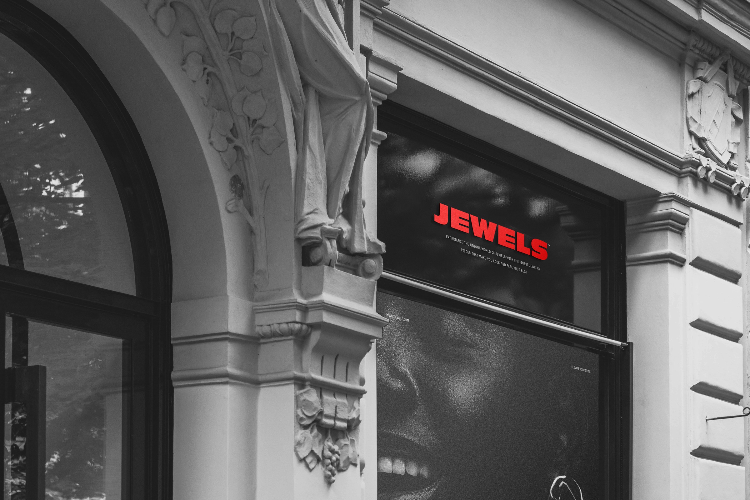 A store window under a stone arcade carrying the Jewels campaign
